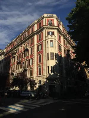 a large red and white building on a city street at Sweet Roman Dream in Rome
