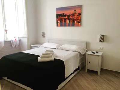 a bedroom with a bed with towels on it at Sweet Roman Dream in Rome