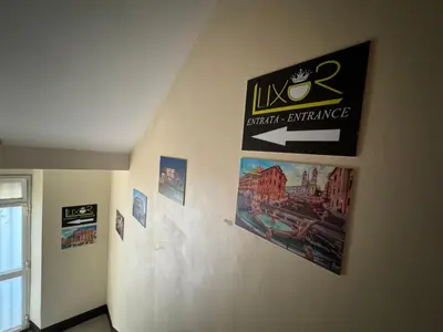 a room with posters and pictures on a wall at LUXOR ECO ROMA CASA E APPARTAMENTO PER VACANZE IN CENTRO Piazza Bologna, Colosseo, Piazza di Spagna, Vaticano, San Pietro, Sapienza, Fontana di Trevi, Piazza Navona, Trastevere, Tiburtina, Termini, Aeroporto in Rome