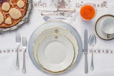 a table with a plate of food and silverware at Relais Donna Lucrezia in Rome