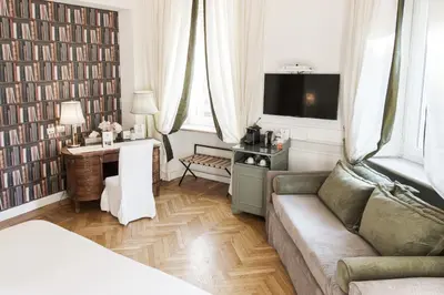 a living room with a couch and a table with a television at Relais Donna Lucrezia in Rome