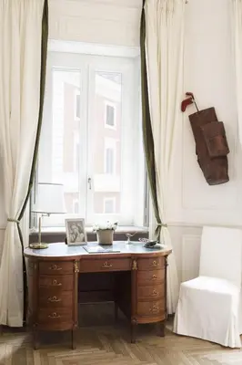 an office with a desk in front of a window at Relais Donna Lucrezia in Rome