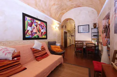 a living room with a couch and a dining room at Lupa Flat in Rome