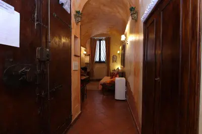 a hallway with a room with a bed and a door at Lupa Flat in Rome