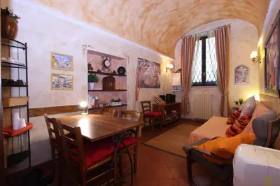 a living room with a table and a dining room at Lupa Flat in Rome