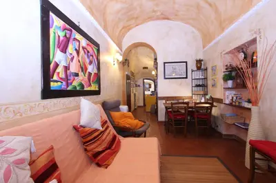 a living room with a couch and a dining room at Lupa Flat in Rome
