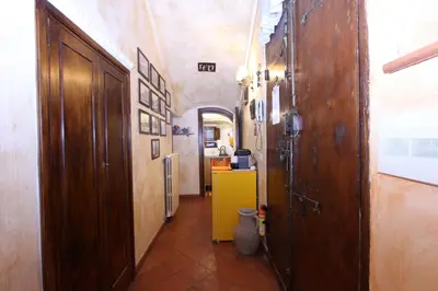 a hallway with a door and a yellow cabinet at Lupa Flat in Rome
