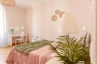 a picture of pink peonies next to a framed picture at Florje House in Rome