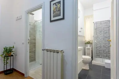 a bedroom with a bed and a chandelier at Florje House in Rome