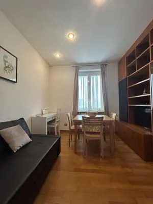 a living room with a table and a dining room at Appartamento con Terrazza vicino Gemelli e Vaticano in Rome