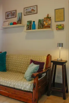 a living room with a couch and a table with a lamp at Alfieri home holiday in Rome