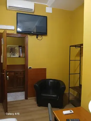 a small bedroom with a bed with a blue blanket at OK Roma in Rome