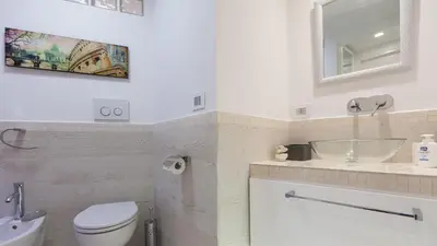 a bathroom with a toilet and a sink and a mirror at Rental in Rome Palermo apartment in Rome