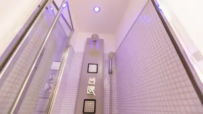 a room with purple walls and a glass wall at Rental in Rome Palermo apartment in Rome