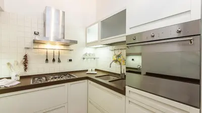 a kitchen with white cabinets and stainless steel appliances at Rental in Rome Mial house in Rome