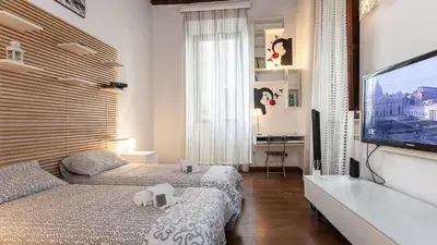 a bedroom with two beds and a flat screen tv at Rental in Rome Mial house in Rome