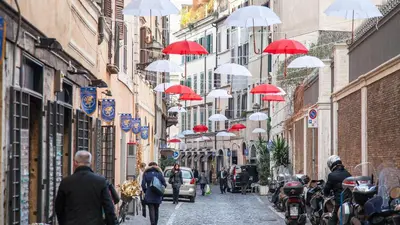 a group of red and white umbrellas hanging from buildings at Rental in Rome Mial house in Rome