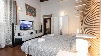 a bedroom with two beds and a flat screen tv at Rental in Rome Mial house in Rome