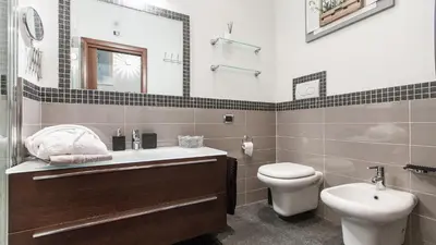 a bathroom with a sink toilet and a mirror at Rental in Rome Mial house in Rome