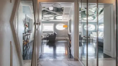 a living room with a hallway with a mirror at Rental in Rome Flaminio View Suite in Rome