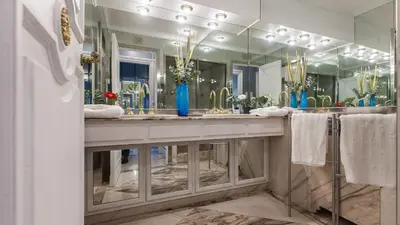 a bathroom with two sinks and a large mirror at Rental in Rome Flaminio View Suite in Rome
