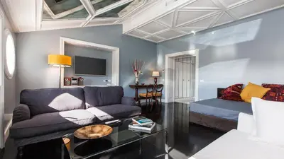 a living room with a couch and a table at Rental in Rome Flaminio View Suite in Rome