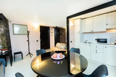 a living room with a table and a kitchen at Rental in Rome Navona Loft in Rome