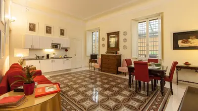 a large living room with a table and a kitchen at Rental in Rome Ghetto Garden in Rome