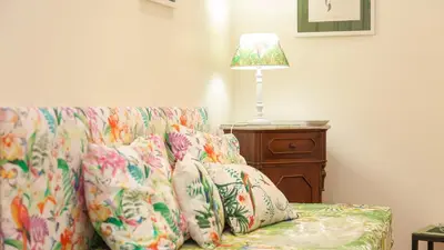 a living room with a couch with a lamp on it at Rental in Rome Ghetto Garden in Rome