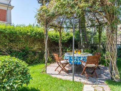 a table and chairs under a pergola in a yard at Villa Michelangelo Deluxe in Rome