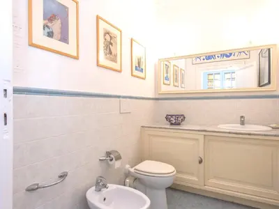 a bathroom with a toilet and a sink and a mirror at Villa Michelangelo Deluxe in Rome