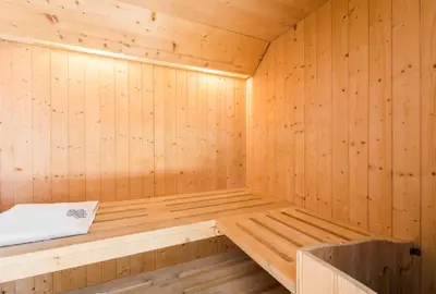 a wooden sauna with a bench in it at Villa Michelangelo Deluxe in Rome