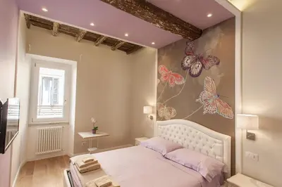 a bedroom with a bed with butterflies on the wall at Boschetto 124 Apartment in Rome