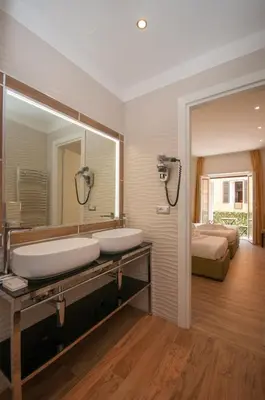 a bathroom with two sinks and a large mirror at Vatican Relais Rome in Rome