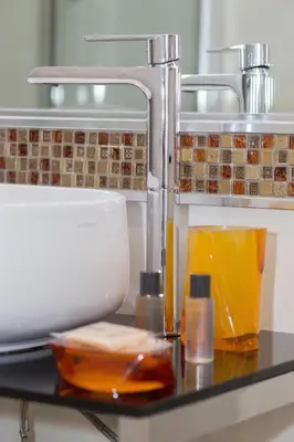 a kitchen counter with a mixer and bottles of liquid at Vatican Relais Rome in Rome