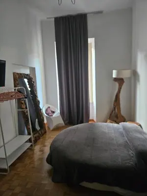 a bedroom with a large bed and a window at Apartment Rome 18 in Rome
