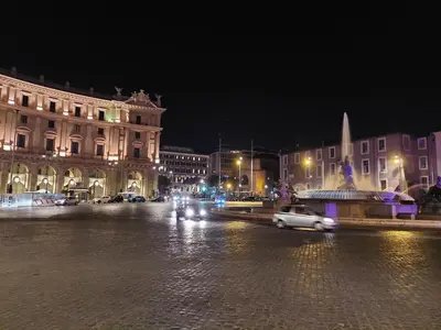a city street at night with cars and buildings at Apartment Rome 18 in Rome