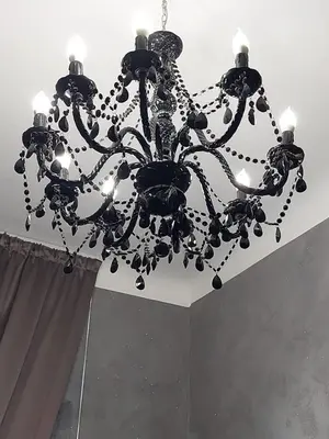 a large black chandelier hanging from a ceiling at Apartment Rome 18 in Rome
