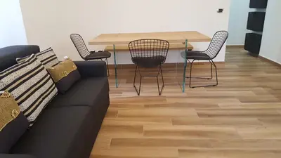 a living room with a couch and a table and chairs at Una Finestra su Monti in Rome