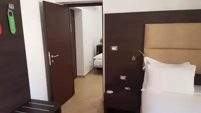 a bedroom with a bed and a door leading into a room at Una Finestra su Monti in Rome