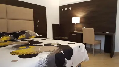 a bedroom with a bed and a desk and a desk at Una Finestra su Monti in Rome