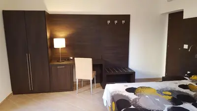 a bedroom with a desk and a bed and a table at Una Finestra su Monti in Rome