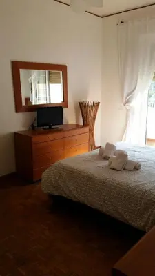 a bedroom with a bed and a tv on a dresser at The Voice of the Pope in Rome