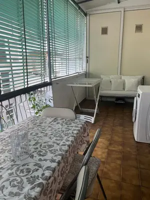 a room with a bed and a table and windows at The Voice of the Pope in Rome