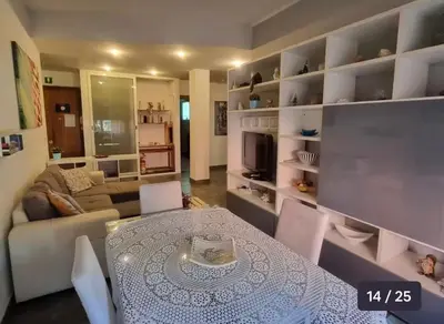 a living room with a table and a couch at The Voice of the Pope in Rome