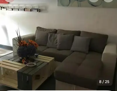 a living room with a couch and a coffee table at The Voice of the Pope in Rome