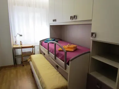 a bunk bed in a small room with a table at Latere Vatican Loft in Rome