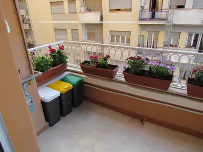 a balcony with buckets of flowers and trash cans at Latere Vatican Loft in Rome