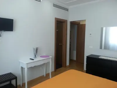 a living room with a white table and a television at Latere Vatican Loft in Rome