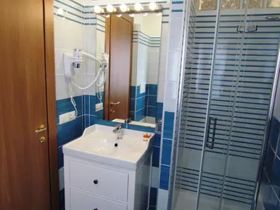 a bathroom with a sink and a shower at Latere Vatican Loft in Rome